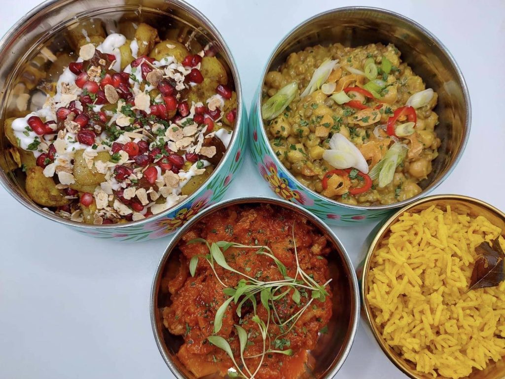 a tiffin unstacked to show the food inside