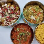 a tiffin unstacked to show the food inside